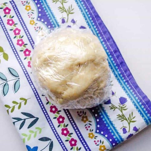 shortcrust pastry dough in cling wrap.