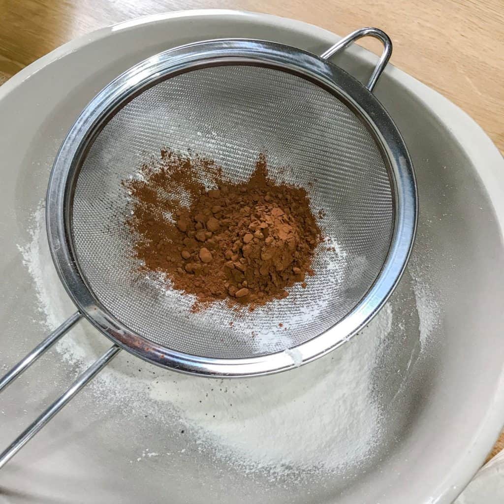 Sieve with flour and cocoa powder