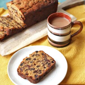 slice of yorkshire barm brack on plate with mug of tea.
