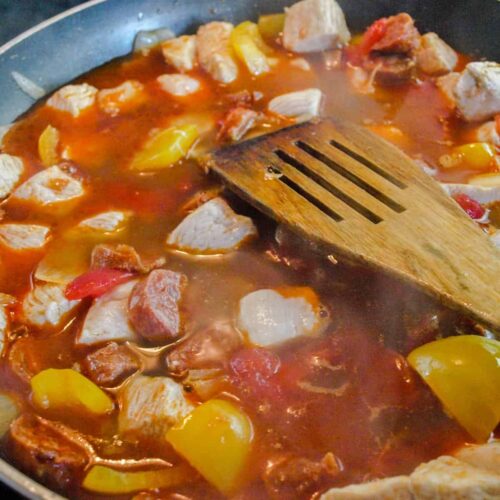 Paella chicken and tomatoes added