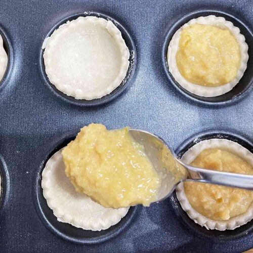 Adding teaspoon of filling to Mini Teacle Tarts