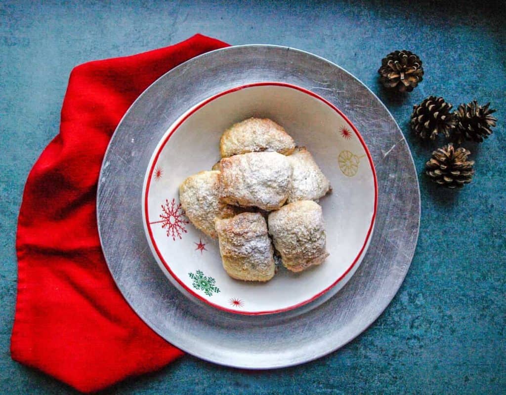 Bowl of Puff Pastry Mincemeat Rolls with pinecones and red cloth