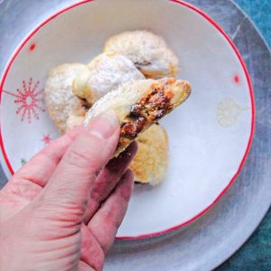 Hand holding Puff Pastry Minemeat Roll