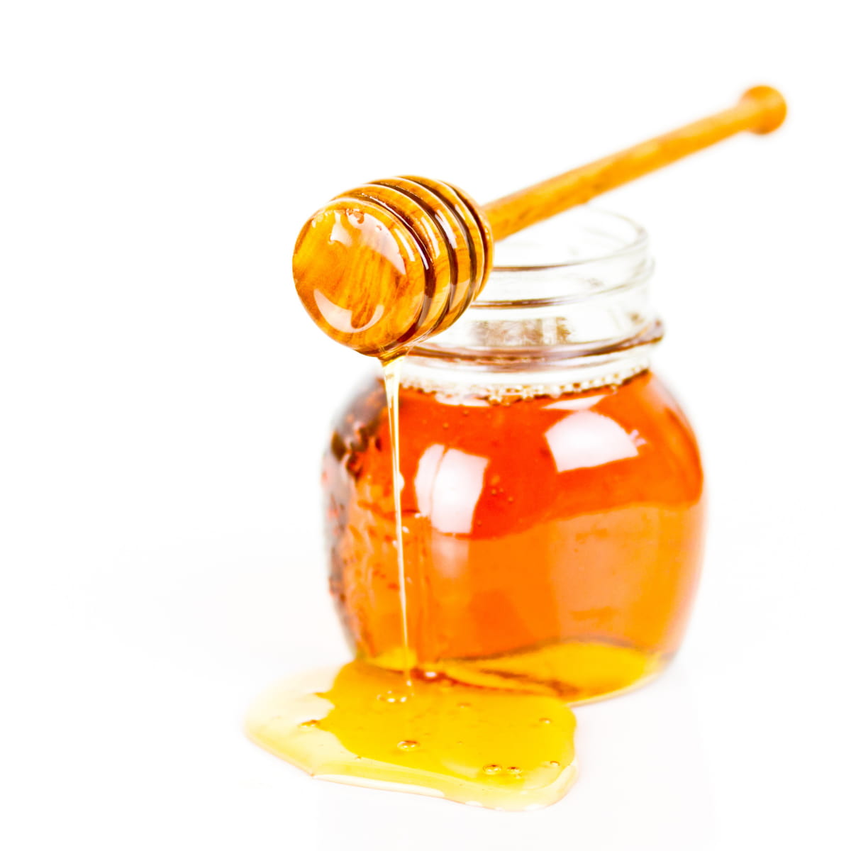 jar of honey with honey dipper