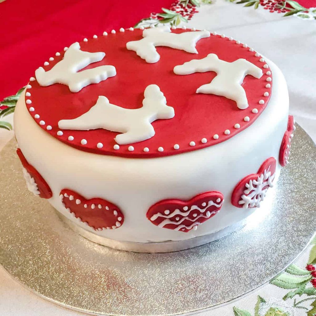 Iced Red and White Christmas Cake with hears and reindeer.