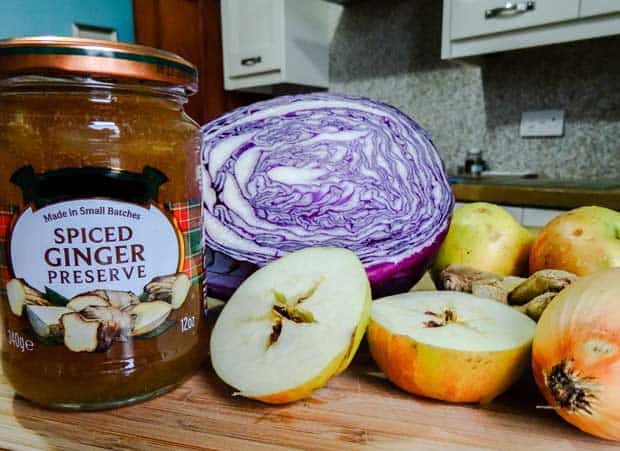 jar of ginger preserve, half a red cabbage, apples and onions.