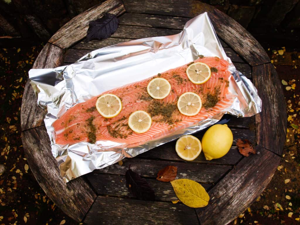 A side of salmon baked with herbs and lemon, perfect to feed a crowd.