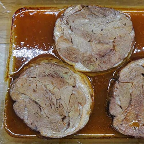 three slices of cooked lamb in stock