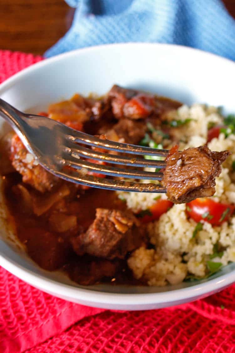 slow cooker lamb ras el hanout on fork.
