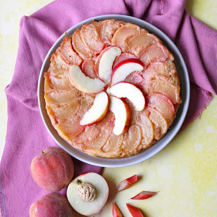 peach and rhubarb upside down cake with peaches and rhubarb pieces.