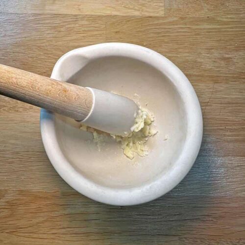 mortart and pestle with garlic.