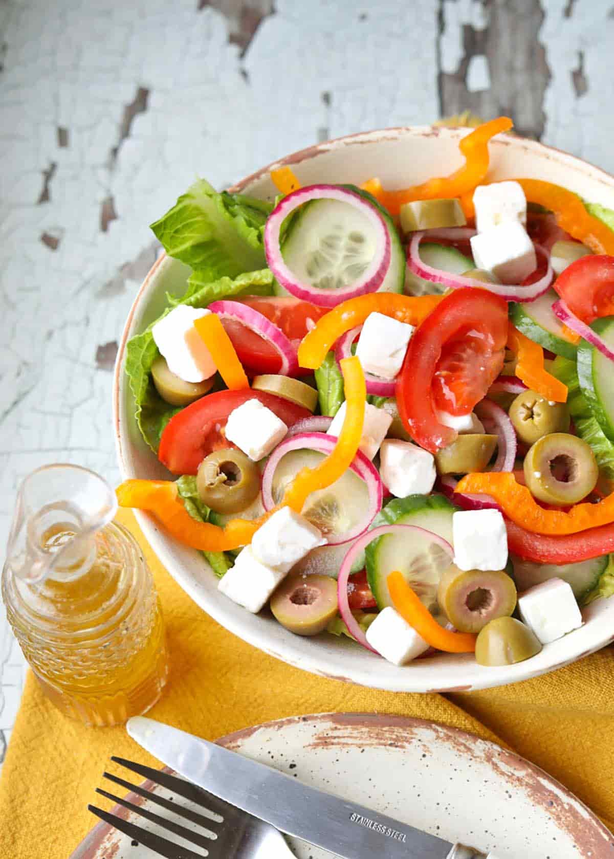 Greek Salad in bowl with knife and fork