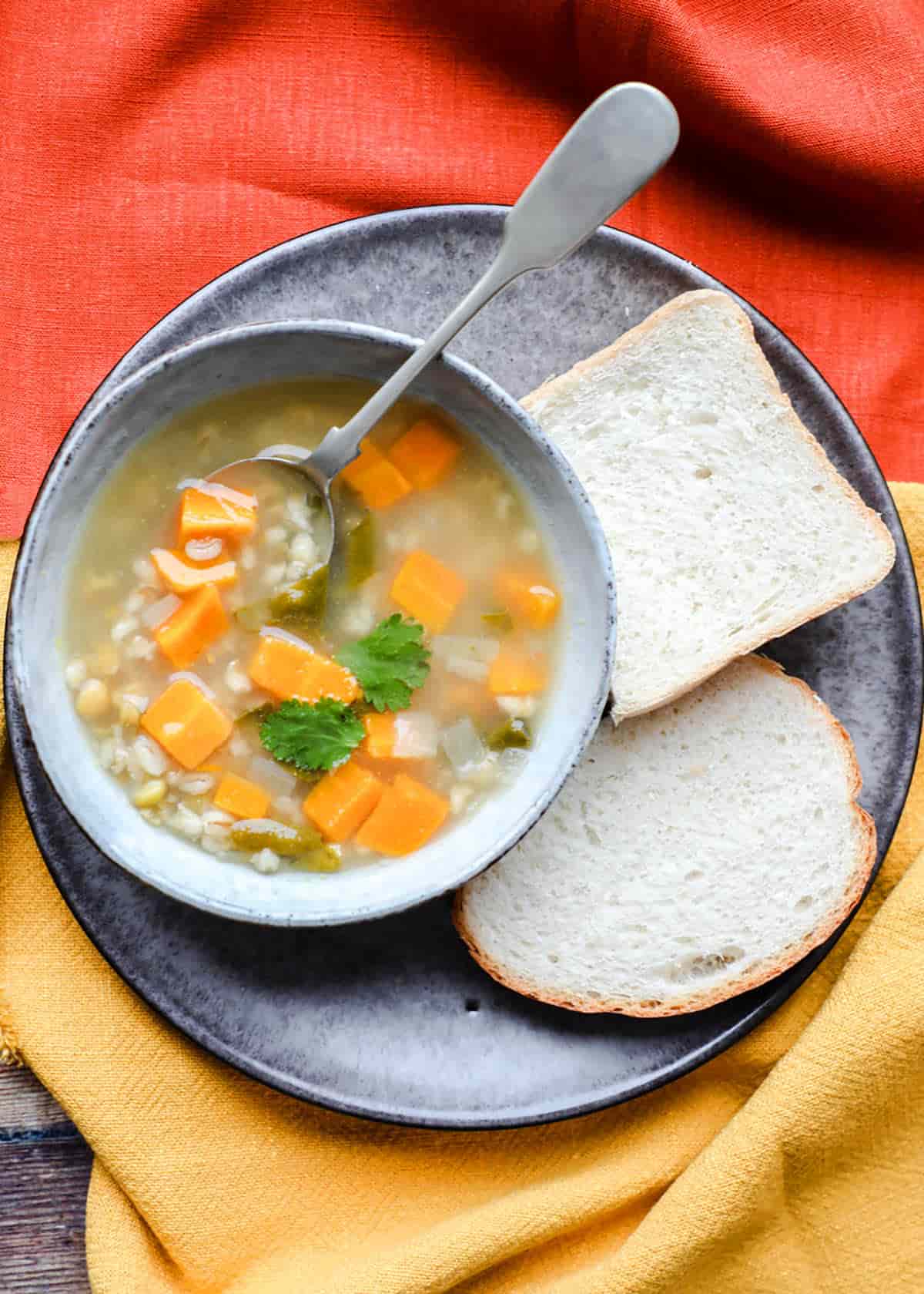 Scotch Broth in bowl with bread on plate