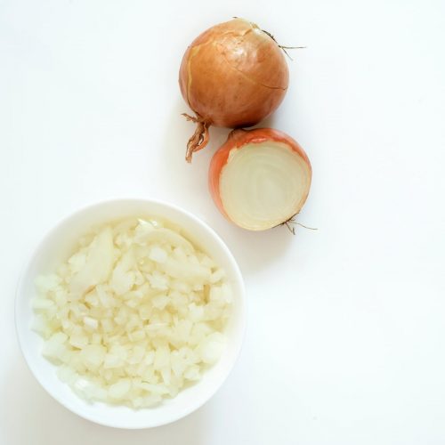 Onion halved and bowl of chopped onions