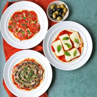 Air Fryer Pitta Pizzas on plates with olives