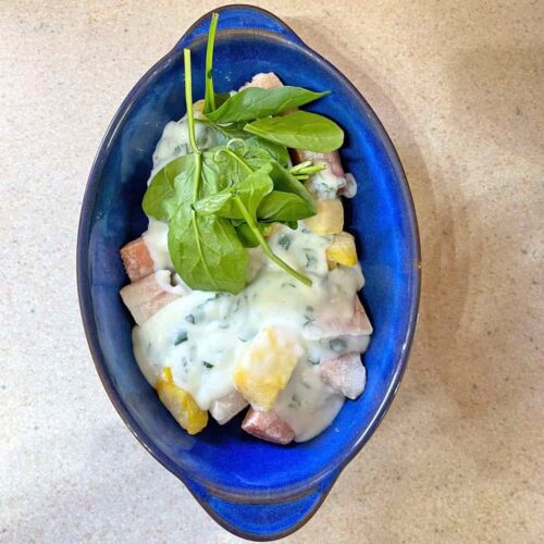dish with fish, spianch and white sauce