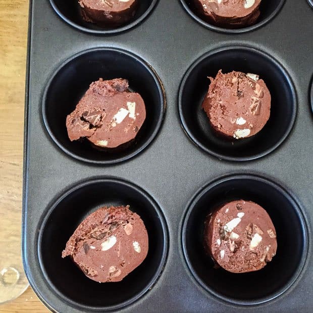 unbaked cookie dough in muffin tin for Cookie cups