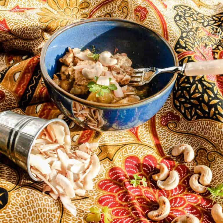 Bowl of chicken curry with cashews and coconut