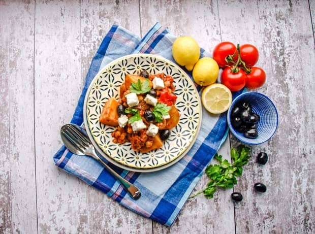 Plate of Vegetarian Greek Baker's Pot with olives, tomatoes and lemons