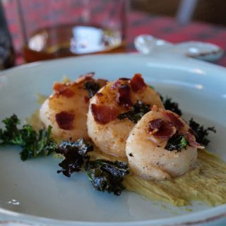 Pan Fried Scallops on a Leek Puree with crispy bacon and kale chips