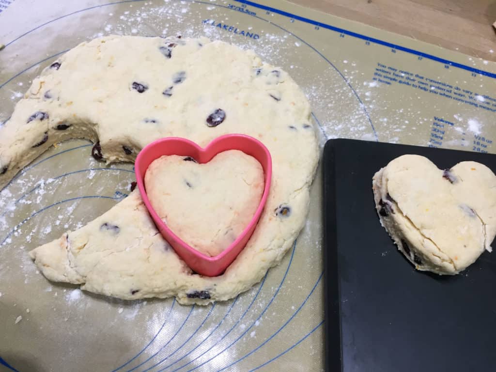 Cutting out heart shaped Cranberry Orange Scones