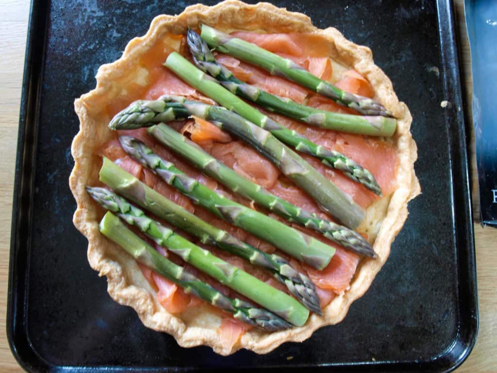 Top the smoked salmon with trimmed asparagus spears