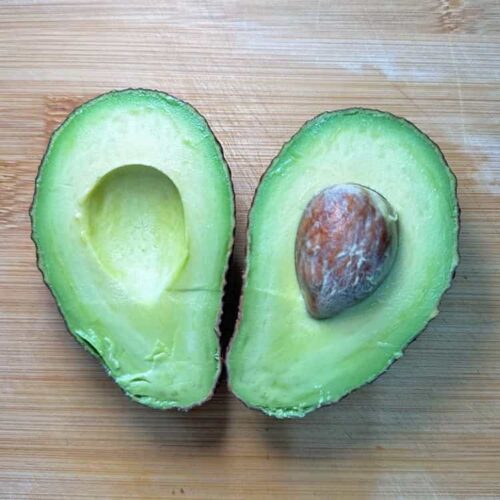 Avocado halves with stone.