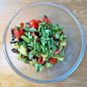 Mix ingredients for Avocado salsa in bowl.
