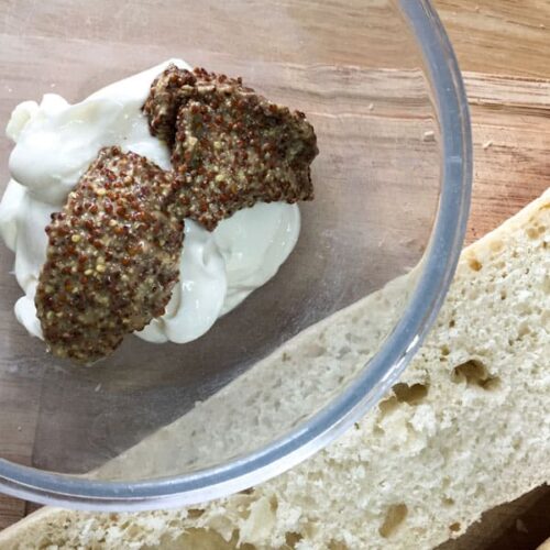 Spread the grain mustard and mayonnaise mixture onto the split baguette for the Best Leftover Turkey Club Sub Sandwich