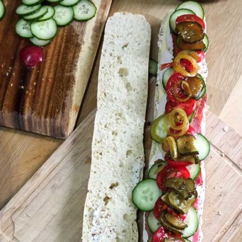 Add the salad and the cucumber pickle all the way along the length of the Best Leftover, Turkey Club Sub Sandwich