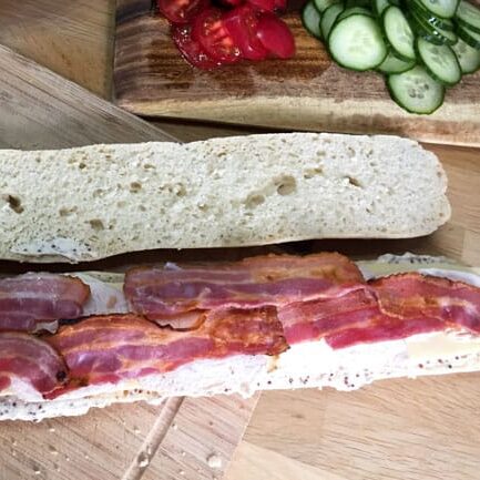 Crisp slices of grilled bacon on top of the turkey on The Best Leftover Turkey Club Sub Sandwich