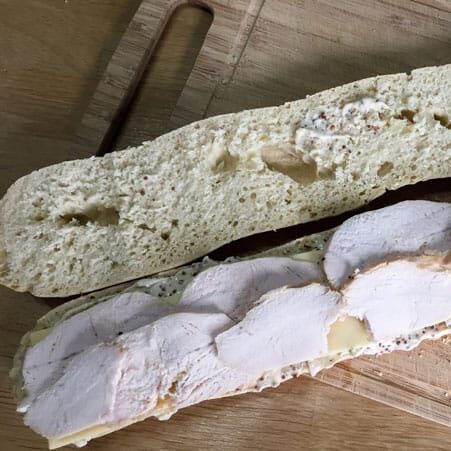 Add layers of cheese and roast turkey slices for the Best Leftover Turkey Club Sub Sandwich
