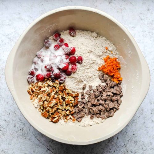 Add cranberries nuts chocolate and orange zest