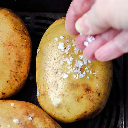 Air Fryer Baked Potatoes spinkle with salt