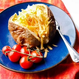 Baked potoato with cheese and cherry tomatoes