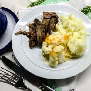 Plate of beef, mashed potatoes and cualiflower cheese