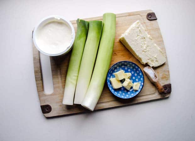leeks, cream butter and cheese on a board 