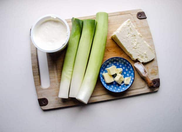 leeks, cream butter and cheese on a board