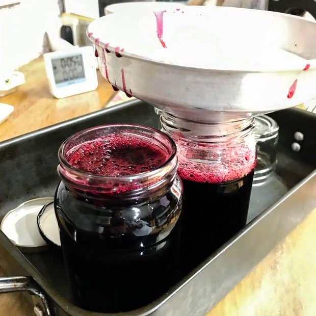 Filling jars with Blackberry & Apple Jelly