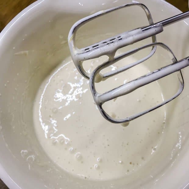 Bowll of beaten eggs and sugar with whisks