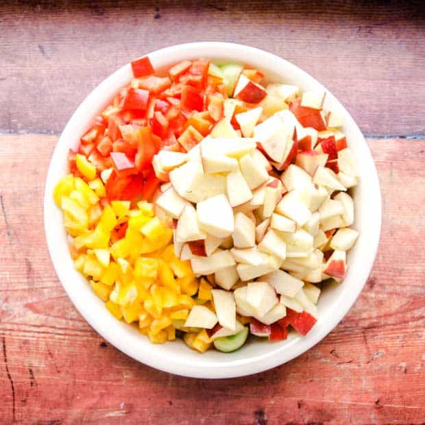 Bowl of chopped apple, peppers, and green tomatoes