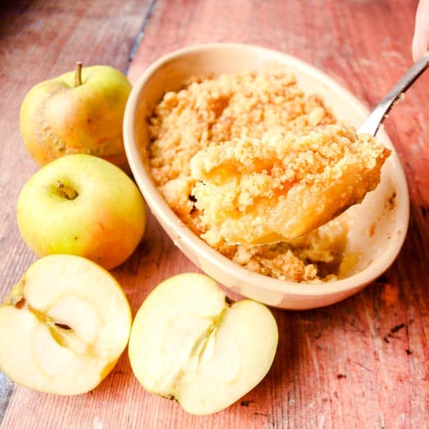 Bowl of Apple Crumble. apples, spoon serving apple crumble