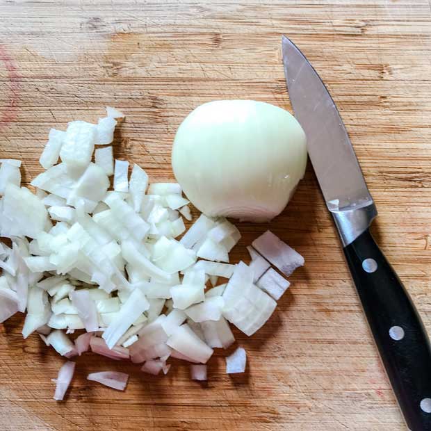 Chopped onion on board with knife