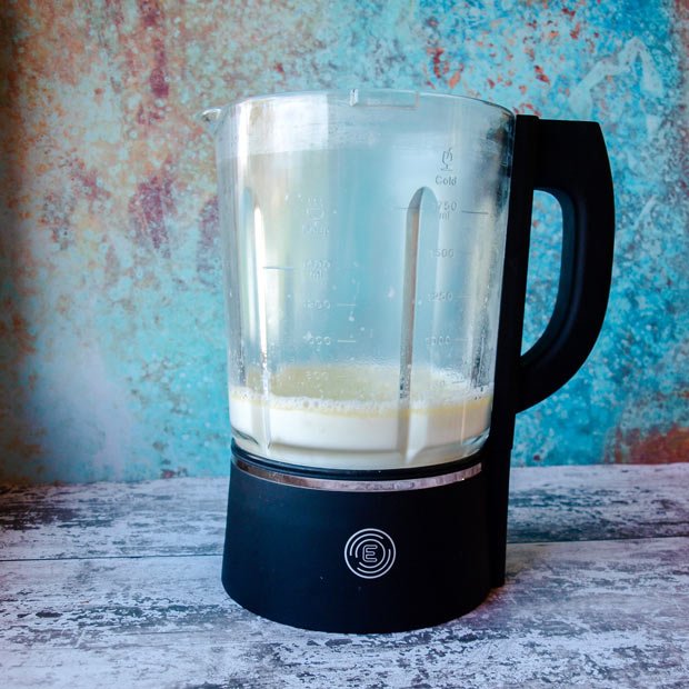 Blender jug with milk in it.