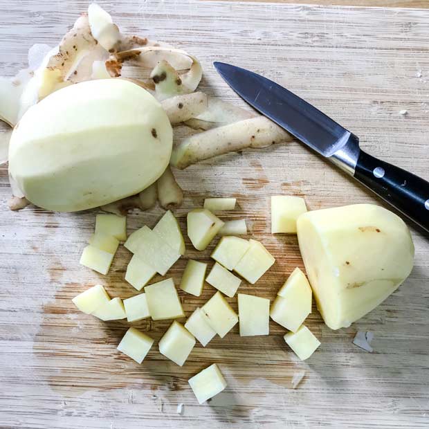 peeled diced potato with knife.