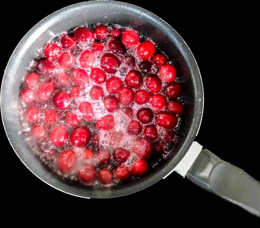 Pan of simmering cranberries.