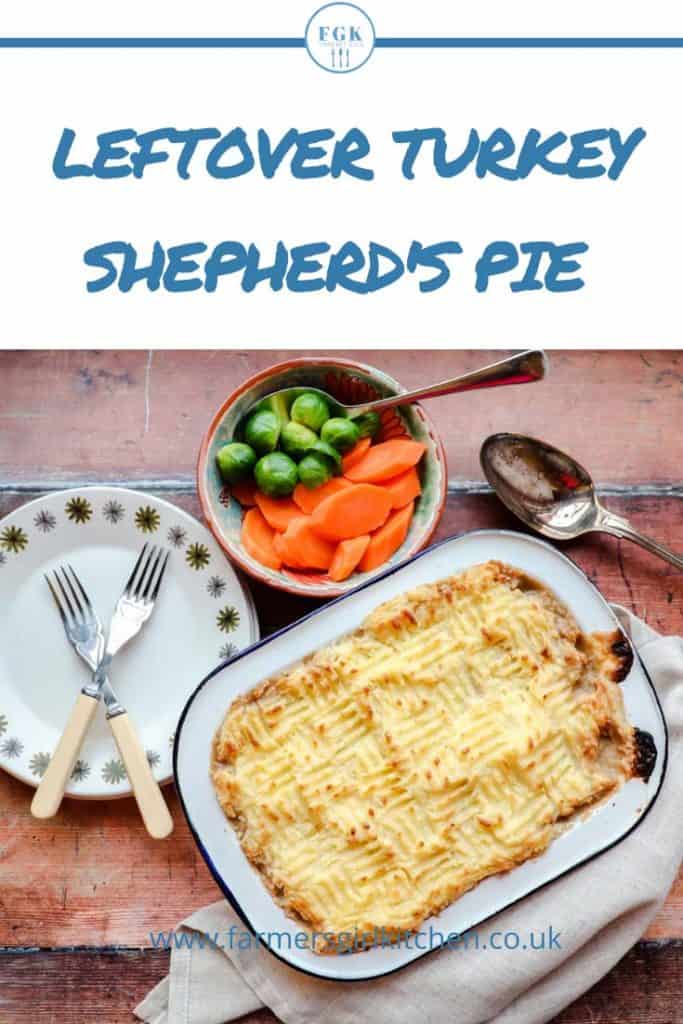 Potato topped turkey pie with plates and bowl of vegetables