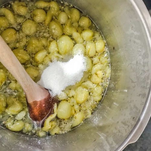 Gooseberries in pan with sugar