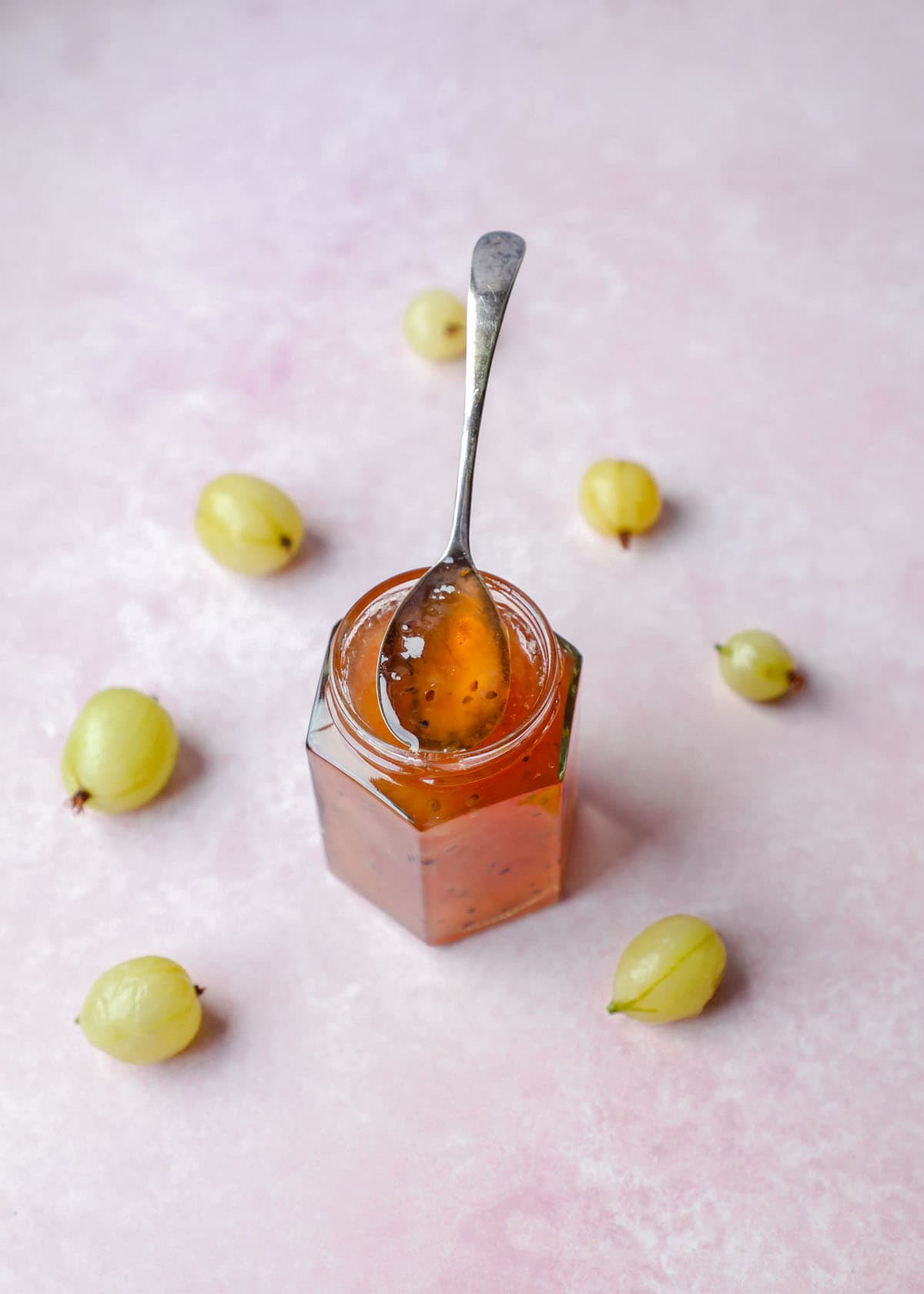 Gooseberry Jam on a spoon with gooseberries