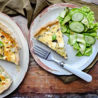 Courgette and Feta Tart on plate with salad and fork